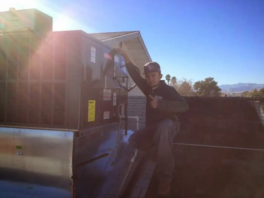 HVAC technician performing Boiler Repair on a rooftop unit in Marlborough